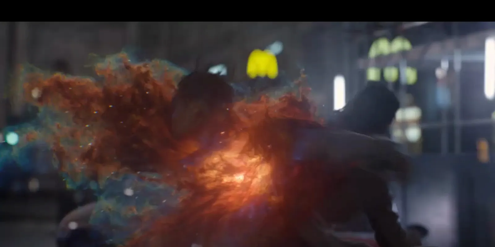 Final shot: the twins erupt in red particle energy on a night street.