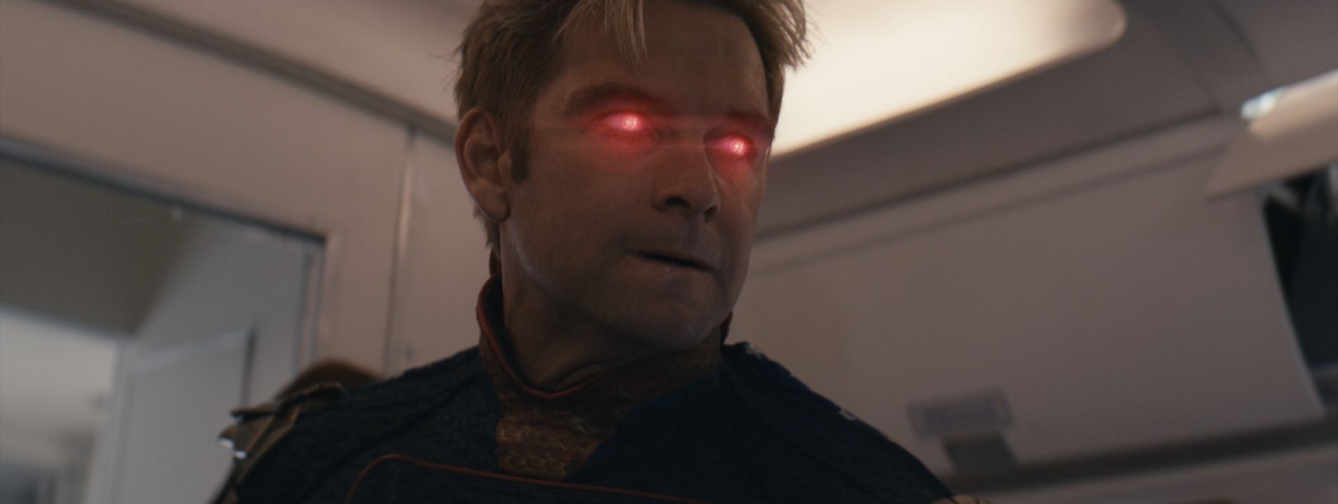 Homelander’s eyes glow red inside an airliner cabin, from The Boys.